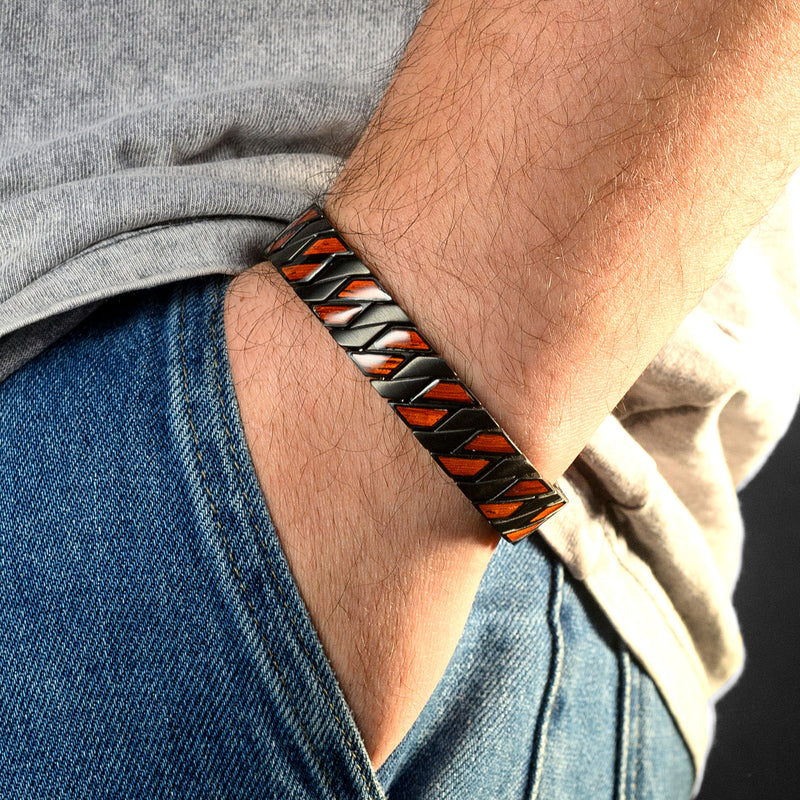 Person wearing a black and red Wood bracelet on a blurred background