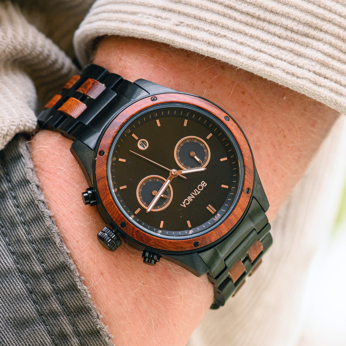 Mens Waterproof Chronograph and date Watch with rosewood and black stainless steel and rosegold inner markings on a mans wrist