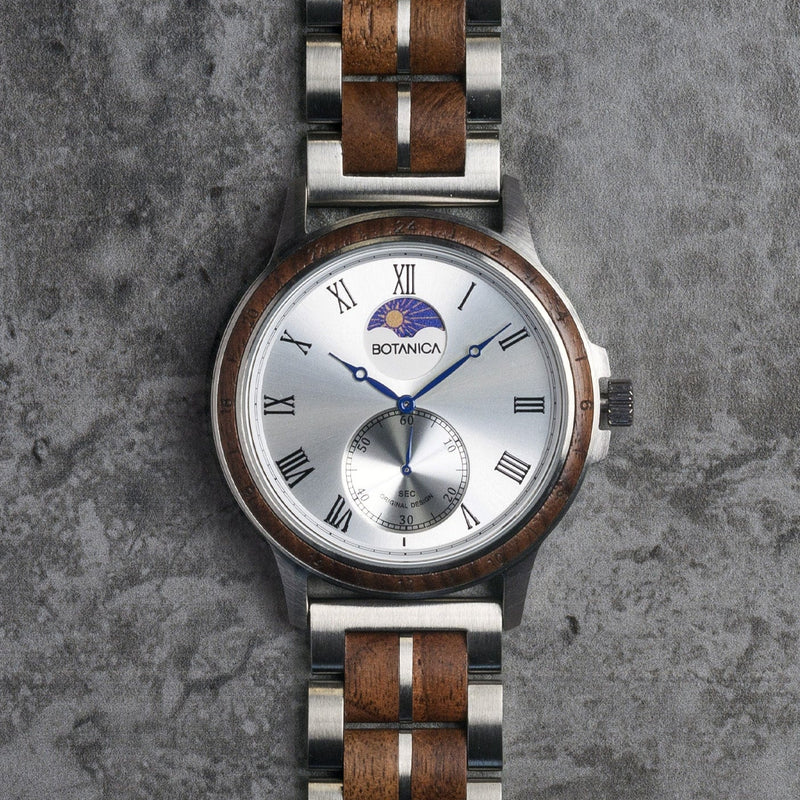 Wooden watch with silver case on a textured gray background