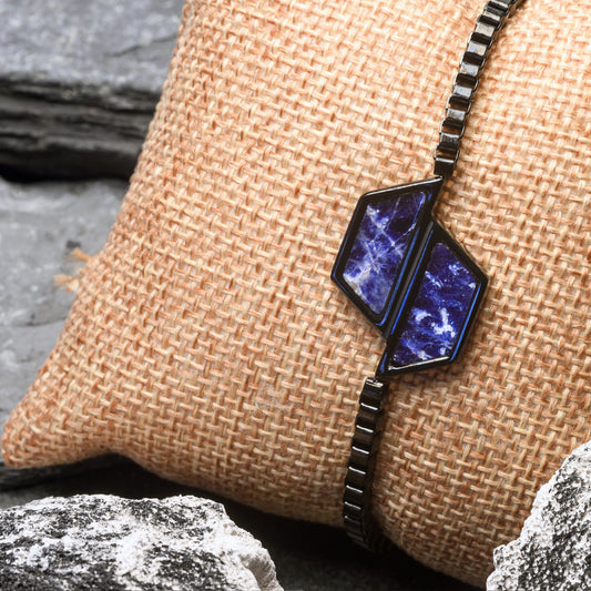 Necklace with a blue pendant on a textured surface