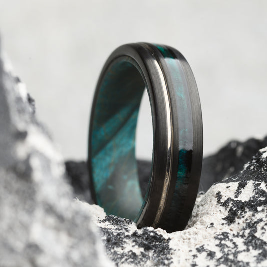 tungsten ring with maplewood inlay on rocky backdrop