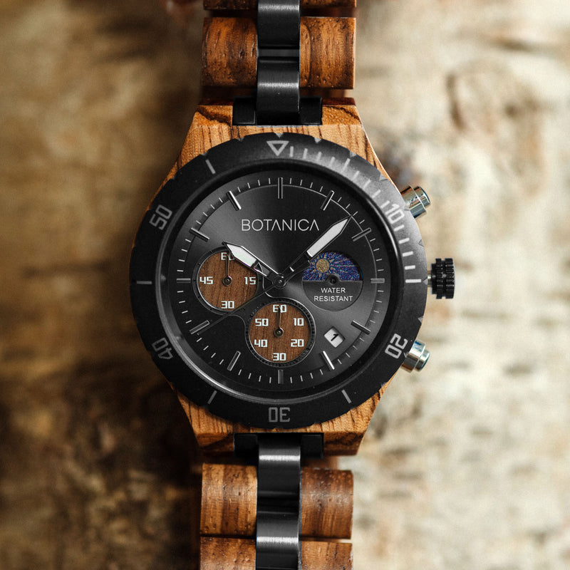 Wooden Watch with Black Bezel Black face and walnut subdial design on a wood textured background