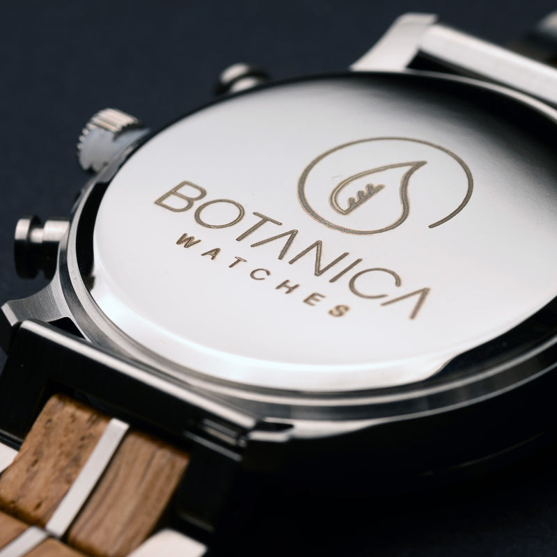Close-up of a Botanica watch with wooden strap on a dark background