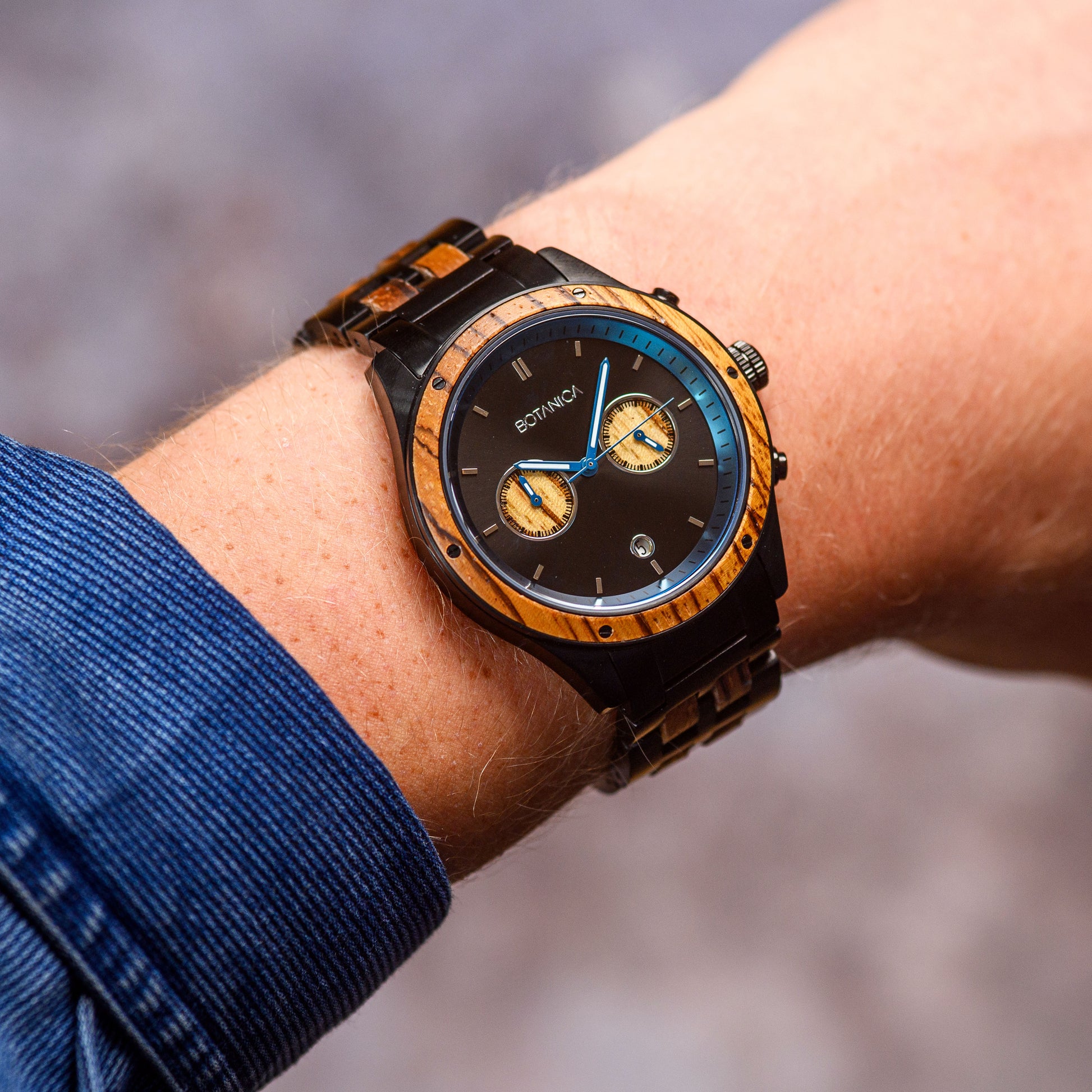 a mens waterproof Zebranowood and black steel chronograph watch being worn on a wrist