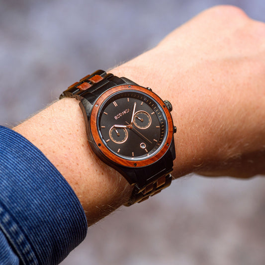 A man wearing a Rosewood and Black Steel chronograph watch with 2 dials 