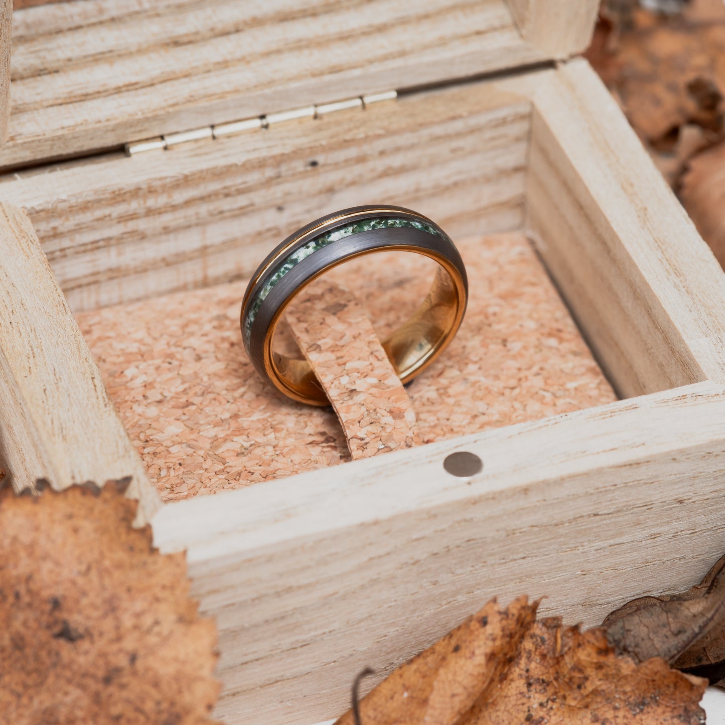 A 6mm Moss Agate and Tungsten Steel Ring sitting in a wooden box