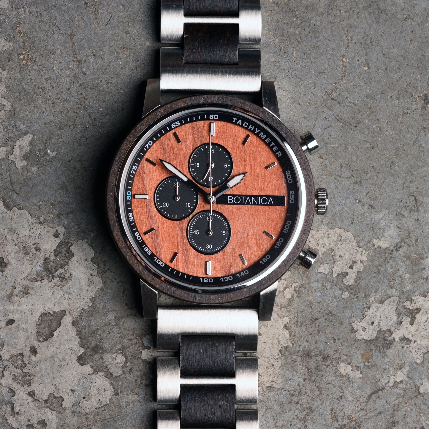 Sandalwood Watch with wooden face and metal strap on a textured surface