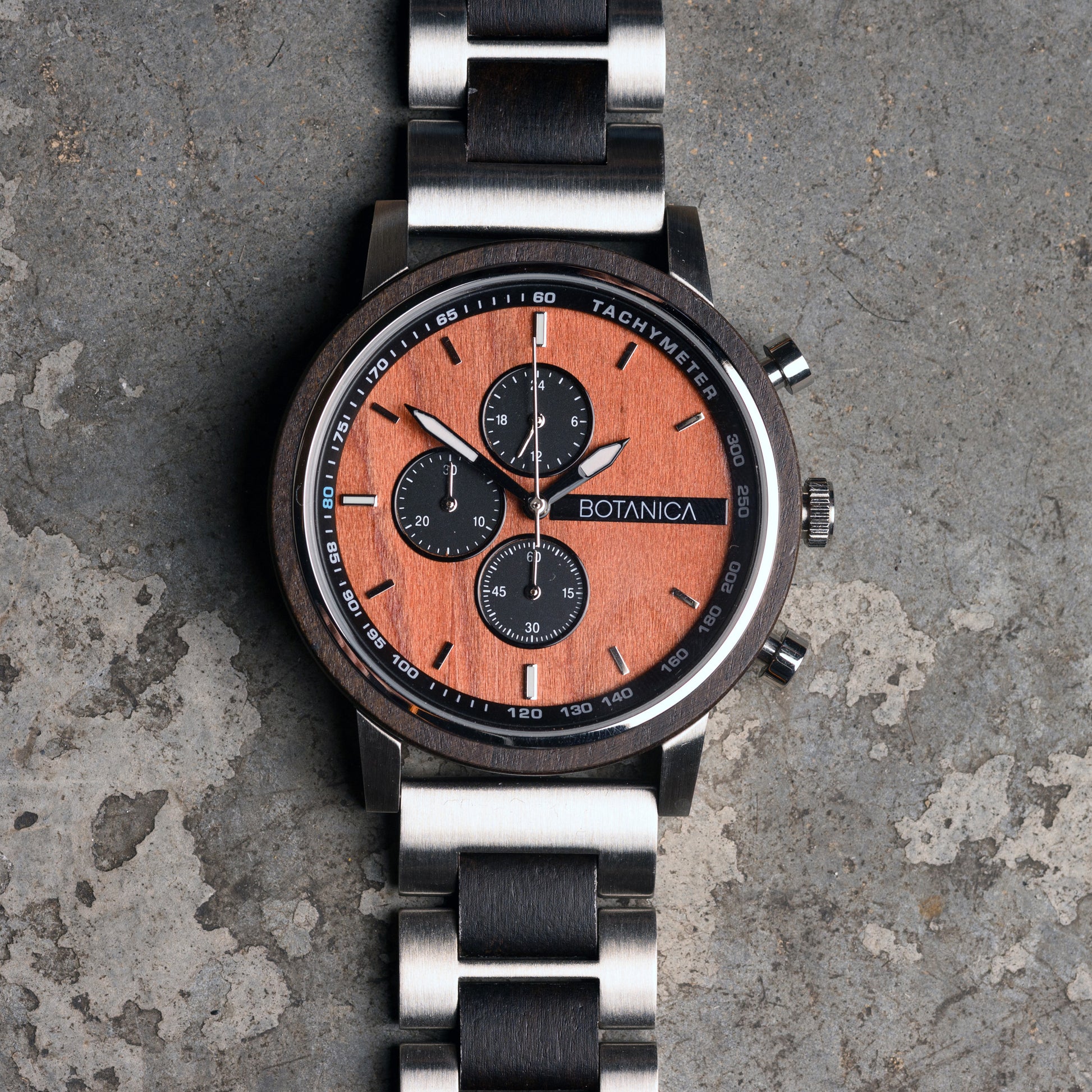 Sandalwood Watch with wooden face and metal strap on a textured surface