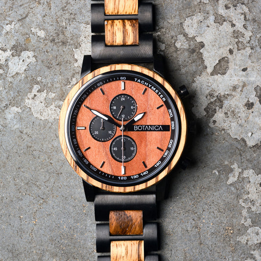 Zebrano Wooden watch with black accents on a textured surface