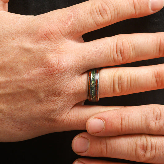 man wearing a moss agate and rosewood ring close up of model hand shot