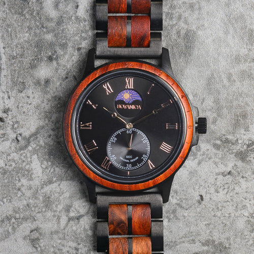 Wooden watch with black face and detailed design on a textured gray background