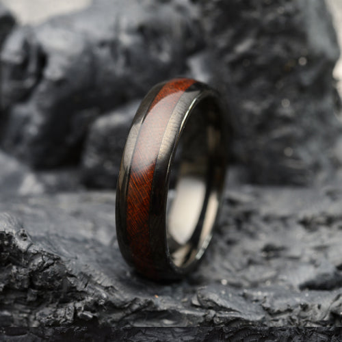 tungsten steel ring with rosewood band sitting on stone background for men or women