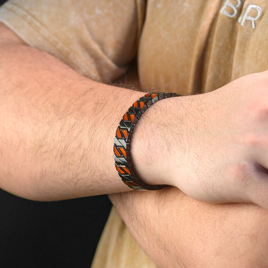 Close-up of a person wearing a black Steel and Wood bracelet on their wrist.