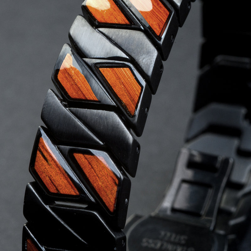 Close-up of a bracelet with geometric wooden inlays into a dark background