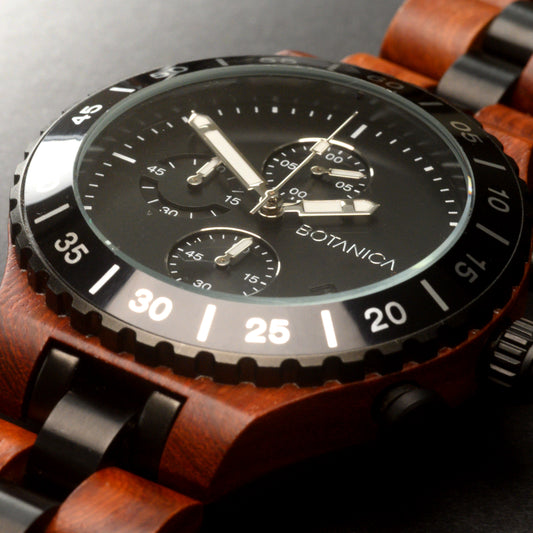 Rosewood Watch with a Woodlink strap and black dial on a dark background