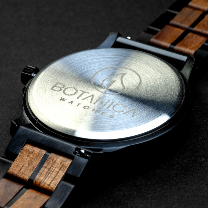 Back of a Watch with wooden strap and visible brand logo on a dark background