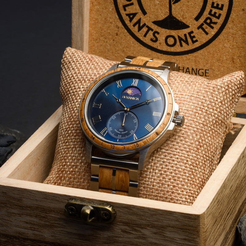 Wooden wristwatch with blue face in a wooden box, brand 'PLANTS ONE TREE' visible