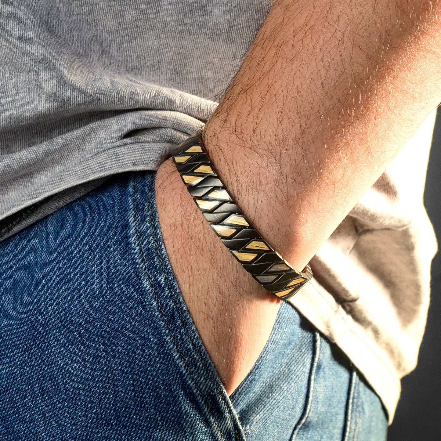 Close-up of a person wearing a Wood and black braided bracelet on their wrist.