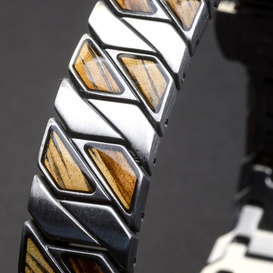 Close-up of a bracelet with geometric design and wooden inlays on a dark background