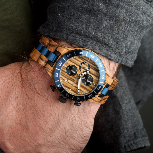 Wooden wristwatch with blue accents on a person's wrist